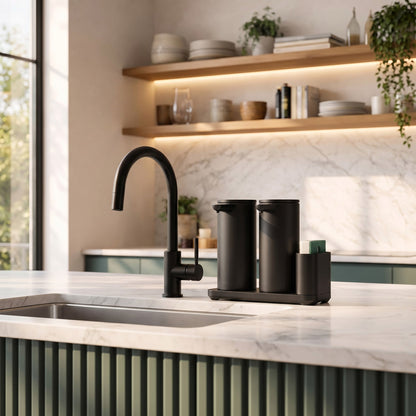 Simplehuman's Dual 14 oz. Sensor Pump in Matte Black in a modern kitchen setting with marble counter top and a hint of green.